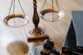 pexels-photo-5669619-5669619 A striking image featuring a brass justice scale and gavel on a wooden desk, symbolizing law and justice.